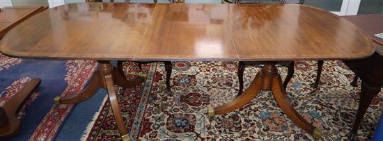 A Georgian style mahogany D end twin pillar extending dining table 230cm extended, one spare leaf